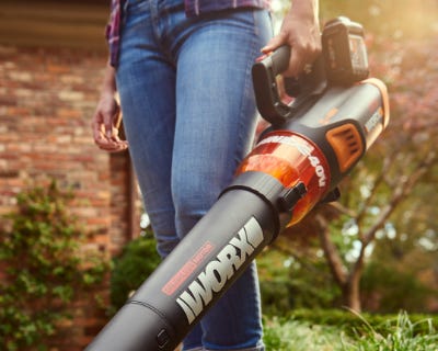 person holding the blower in their left hand